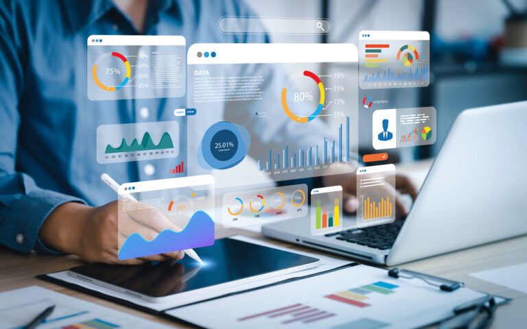 An analyst uses a computer and dashboard for data business analy