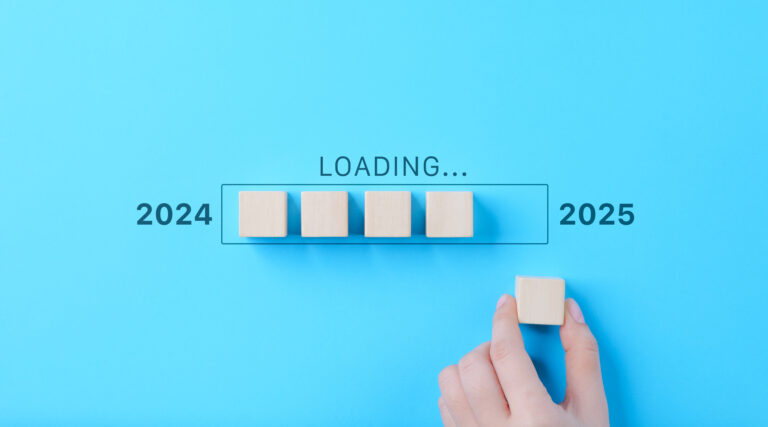 Loading Progress Bar from 2024 to 2025 with Wooden Blocks. A hand places wooden blocks in a row, creating a progress bar transitioning from 2024 to 2025, symbolizing the new year and future progress.